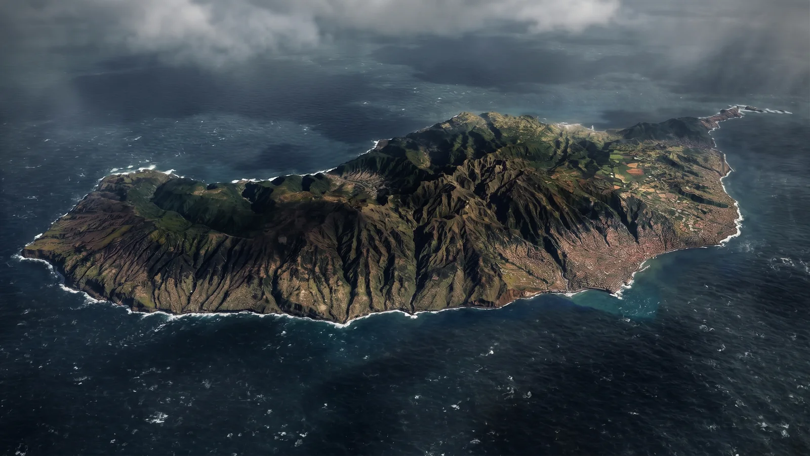 Aerial view of the island of Madeira surrounded by the Atlantic under storm clouds